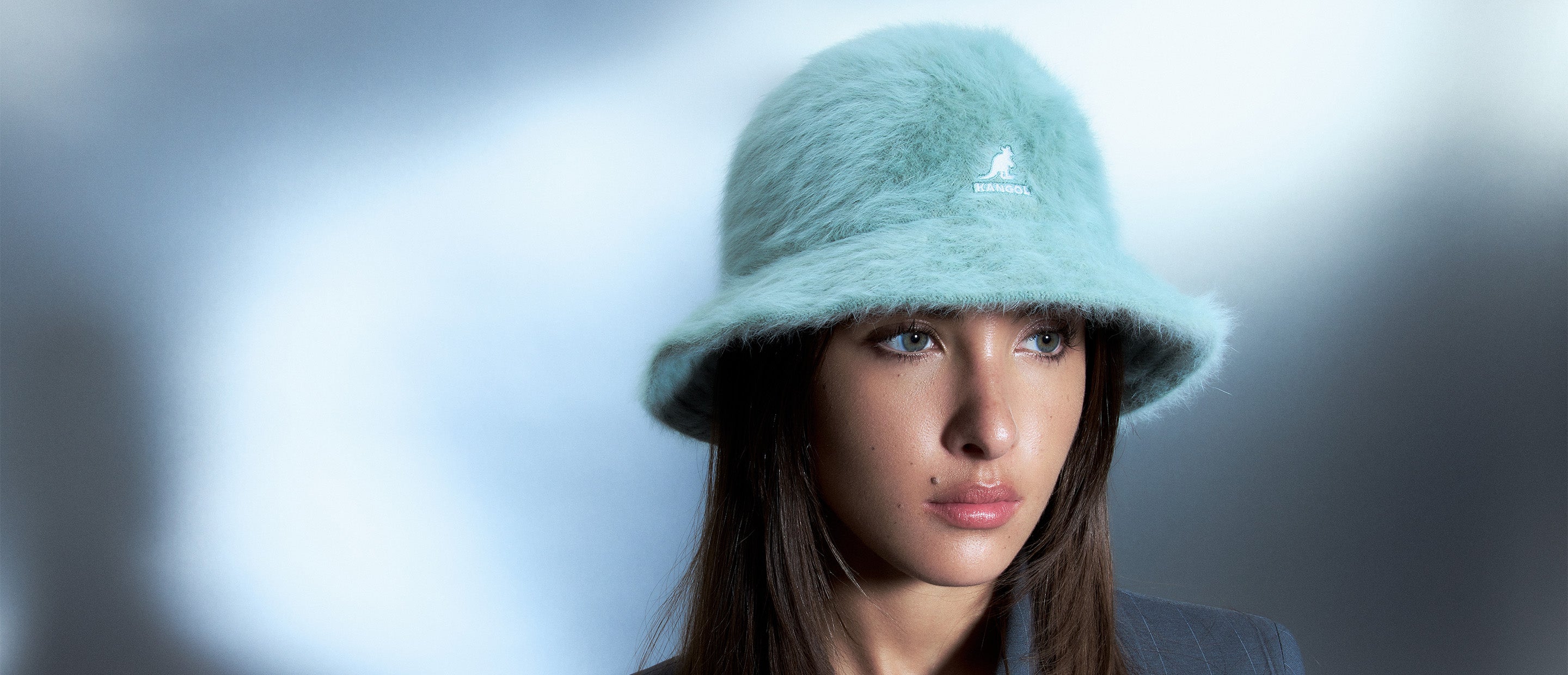 Woman standing in front of blue/gray background wearing Furgora® Casual in Sage Green