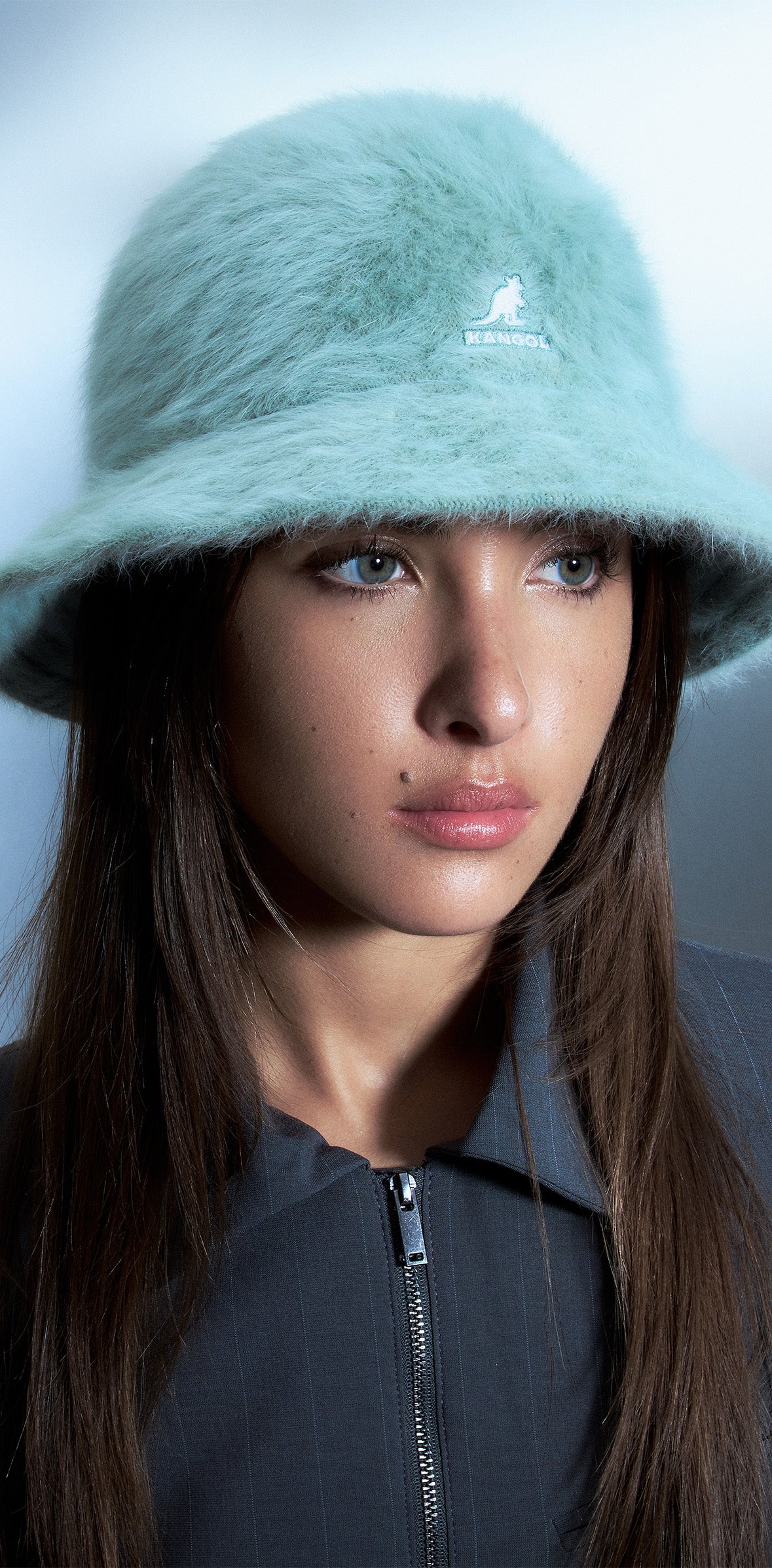 Woman standing in front of blue/gray background wearing Furgora® Casual in Sage Green