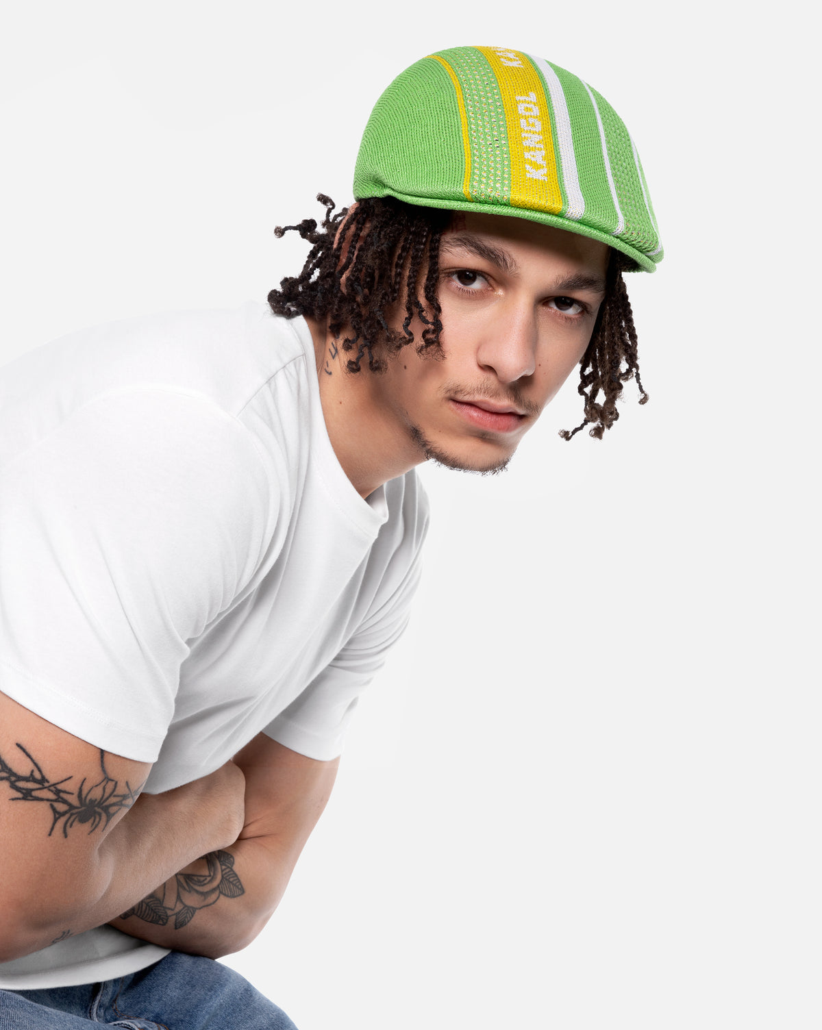 Person wearing a green and yellow cap with a white background