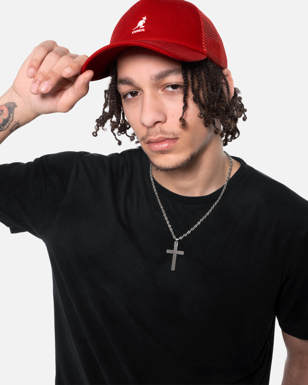 Person wearing a red cap and black shirt with a white background